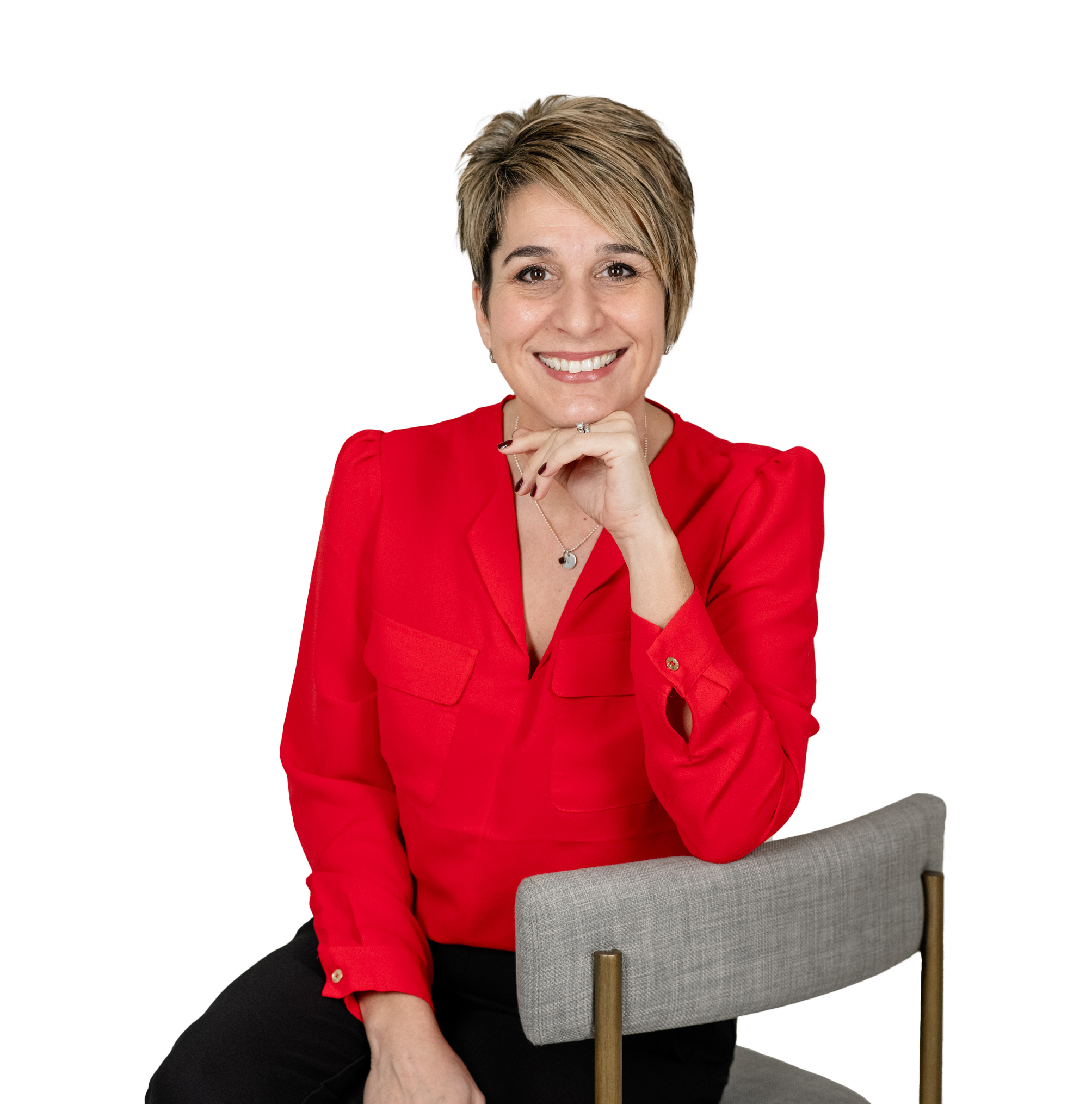 Buffy in a red blouse sitting in a chair